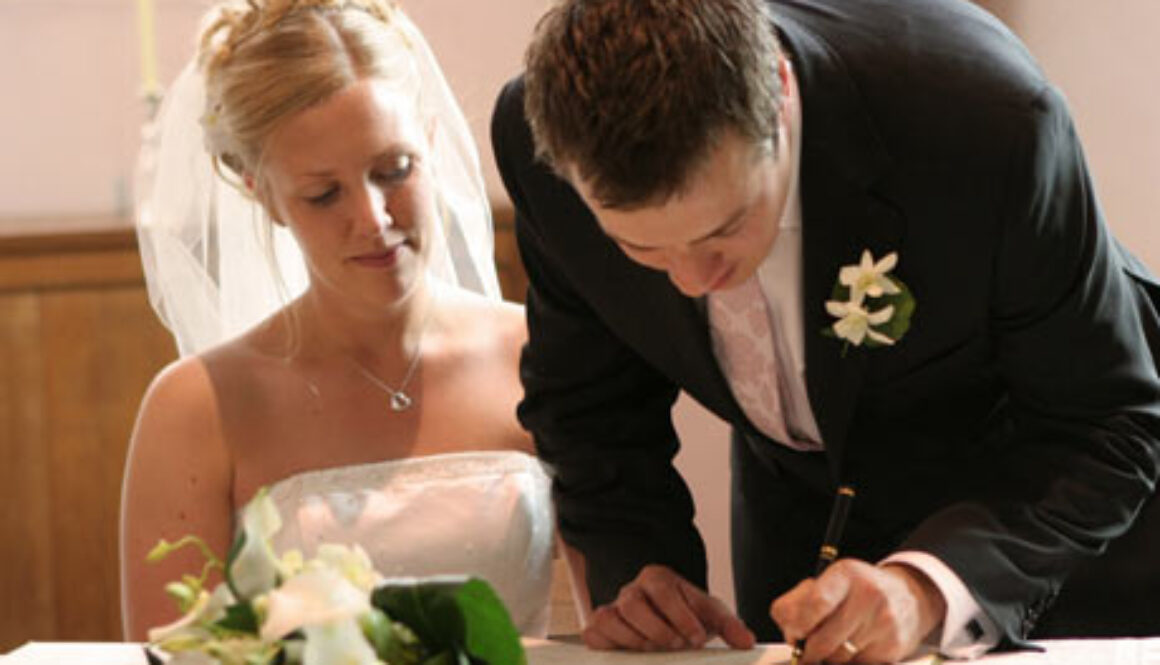 Bride-and-groom-signing-document-460x300.jpg