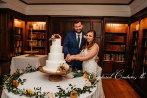 couple cutting wedding cake 