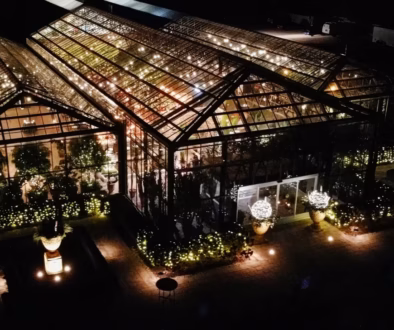 Planterra Conservatory illuminated at night with its iconic glass conservatory and landscaped gardens in West Bloomfield, Michigan.