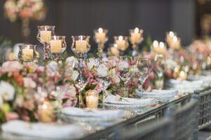 Wedding planner-designed reception with floral centerpieces and candlelight
