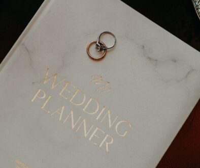 “Wedding planner guide with wedding rings on a planning book, representing luxury wedding planning services in Metro Detroit