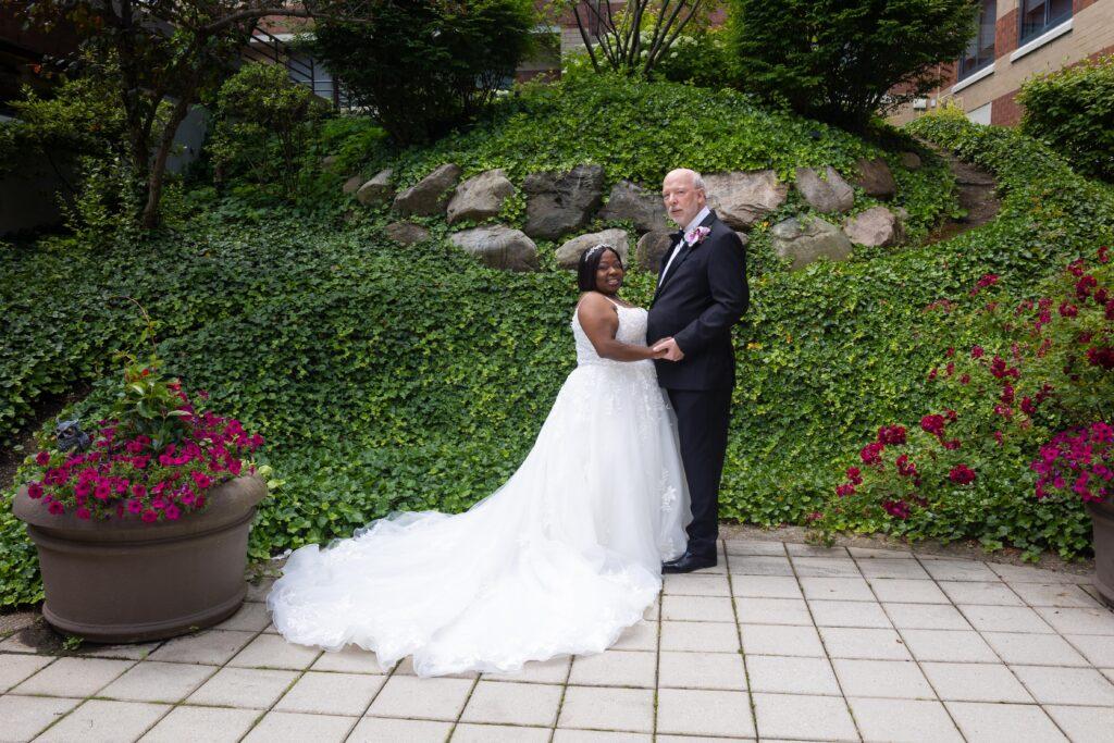 Catrenia and John pose for a romantic garden portrait on their wedding day at The Baronette Renaissance.