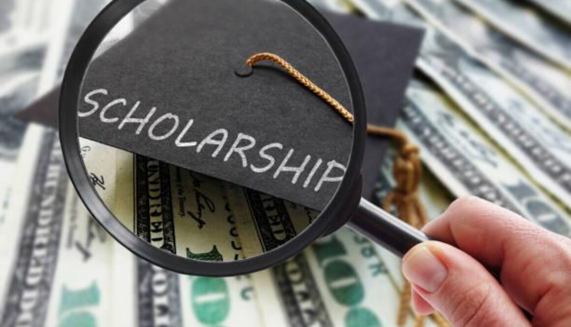 Scholarship graduation cap on money with magnifying glass